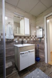 a bathroom with a sink and a mirror at Vila Vrnjački Raj in Vrnjačka Banja