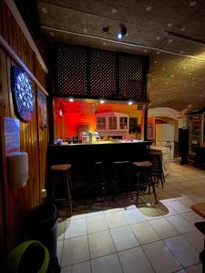 a bar in a restaurant with chairs and a counter at whole basemenet former pub4 stag do/hen party in Budapest