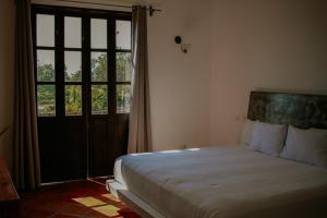 מיטה או מיטות בחדר ב-Hotel Casa Tota