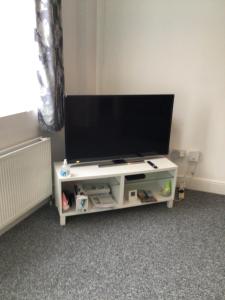 a flat screen tv on a white entertainment center at 96 High Street in Ryde
