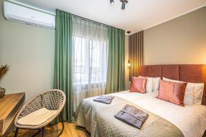 a hotel room with a bed and a chair at Tamara Suites & Apartments in Jūrmala