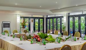 a long table in a room with windows at The Warwick Fiji in Korolevu
