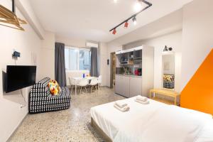 1 dormitorio con 1 cama, 1 silla y 1 mesa en Monastiraki Place, en Atenas