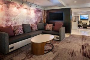 a living room with a couch and a table at Sonesta Select Boston Lowell Chelmsford in Lowell