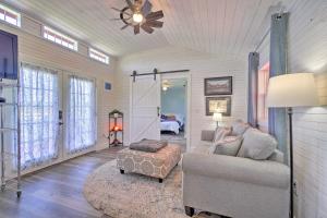 a living room with a couch and a chair and a bedroom at Peaceful Country Cottage with Landscape Views in Sweetwater