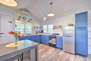 a kitchen with blue cabinets and a refrigerator at Peaceful Country Cottage with Landscape Views in Sweetwater
