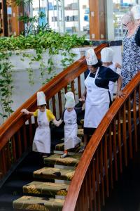 a group of chefs walking down a staircase at The Warwick Fiji in Korolevu
