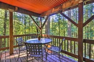 A balcony or terrace at Cozy Sandy Retreat with Hot Tub and Forest Views!