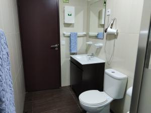 a bathroom with a toilet and a sink at Casa de férias e fins de semana, 5 in Esposende