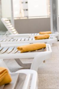 
a row of yellow chairs sitting next to each other at Hotel Traful in Mar del Plata

