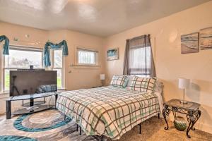 a bedroom with a bed and a flat screen tv at Charming Fort Wayne Home about 1 Mi to Downtown! in Fort Wayne