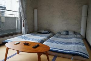 Ένα ή περισσότερα κρεβάτια σε δωμάτιο στο Auberge du Tanuki Noir Maison d'Hôtes
