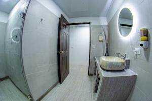 a bathroom with a sink and a mirror at Residencias Arenal in Fortuna