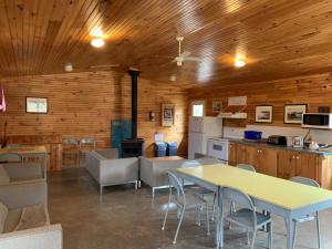 a kitchen and dining room with a table and chairs at New Glasgow Highlands Campground cabins in New Glasgow