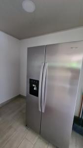 a stainless steel refrigerator in an empty room at Finca Lucky, Samara in Sámara