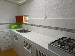 a kitchen with a stove and a sink at Casa Rustica La Bella Filandia in Filandia +13 photos