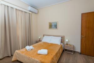 a bedroom with a bed with two towels on it at Katerina Residence in Zakynthos Town