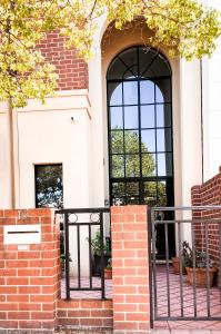 an entrance to a house with a black gate at Ganesha Wellness Spa in Perth