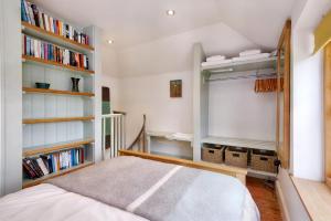 a bedroom with a bed and bookshelves at The Folly in Hereford