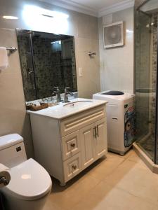 a bathroom with a toilet and a sink and a shower at Homestay coco in Vung Tau