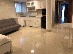 a kitchen and living room with a couch and a table at Homestay coco in Vung Tau