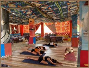 a group of people doing yoga in a room at Nuba Narty in Aswan