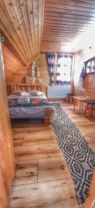 a bedroom with a bed in a wooden room at Casa Utan in Văleni