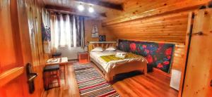 a bedroom with a bed in a wooden cabin at Casa Utan in Văleni