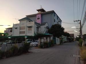 a house with a car parked in front of it at DD Mansion in Ban Talat Rangsit