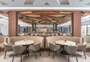 a rendering of a restaurant with tables and chairs at Henann Tawala Resort in Panglao