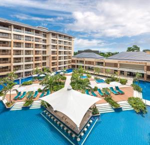 an aerial view of a resort pool with chairs and umbrellas at Henann Tawala Resort in Panglao