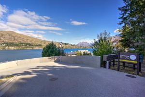 a sign with a view of a lake and mountains at The Villa Lookout - Queenstown Holiday Villa in Queenstown