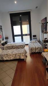 Habitación con 2 camas y ventana grande. en Loft Abad playa Beach Center en Alicante