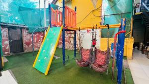 a play room with a slide and swings at FARM HOUSE RESIDENCY in Vasai