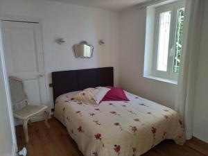 a bedroom with a bed and a window at Maison Trucchi in Menton