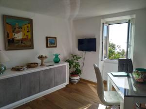 a living room with a desk and a window at Maison Trucchi in Menton