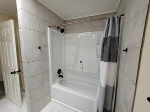 a white bathroom with a tub and a shower at Modern 10 Acre Horse Ranch-Walk to Lake Ray Robert in Pilot Point +20 photos