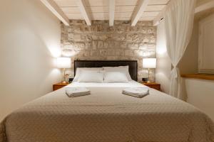 a bedroom with a large bed with two towels on it at Superior 2 Bedroom Apartment Gabriela in Dubrovnik