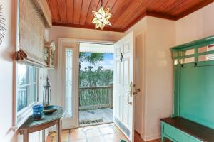 a room with a door leading to a balcony at Ocean Ave Seaside Cottage in Fernandina Beach