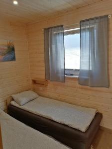 a room with a bed and a window in a cabin at Apartament Antonio 2 Gdańsk in Gdańsk