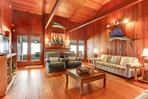a living room with wooden walls and wooden floors at Oceanfront Beach House in Fernandina Beach