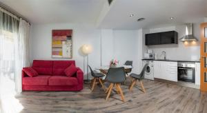 sala de estar con sofá rojo y mesa en Parrot`s House Fenals, en Lloret de Mar