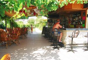 a man sitting at a bar in a restaurant at Özay Apart Otel in Mugla