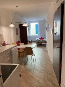 a kitchen and living room with a table and chairs at VERNAZZA CENTRALE in Vernazza