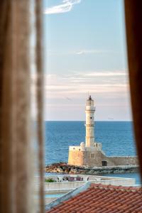 a lighthouse in the ocean with a view of the ocean at Porto Del Colombo Traditional Boutique Hotel in Chania