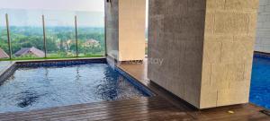 a swimming pool in the middle of a building at Vue by Kozystay - Karawaci in Dadap