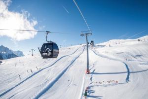 a ski lift on a snow covered ski slope at Ciasa La Palsa App 4 in San Vigilio Di Marebbe