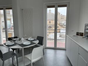 a dining room with a table and a view of the city at La casa di Zoe in Ceglie Messapica