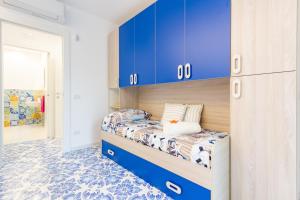 a bedroom with blue cabinets and a bunk bed at Appartamento Sole Alto Plus 2P - MyHo Casa in Vasto