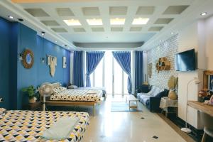 a bedroom with two beds and a living room at The Urban Tuy Hòa Homestay in Liên Trì (3)